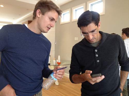 Paul Davison, left, shows off a stealth app at a SF geek party